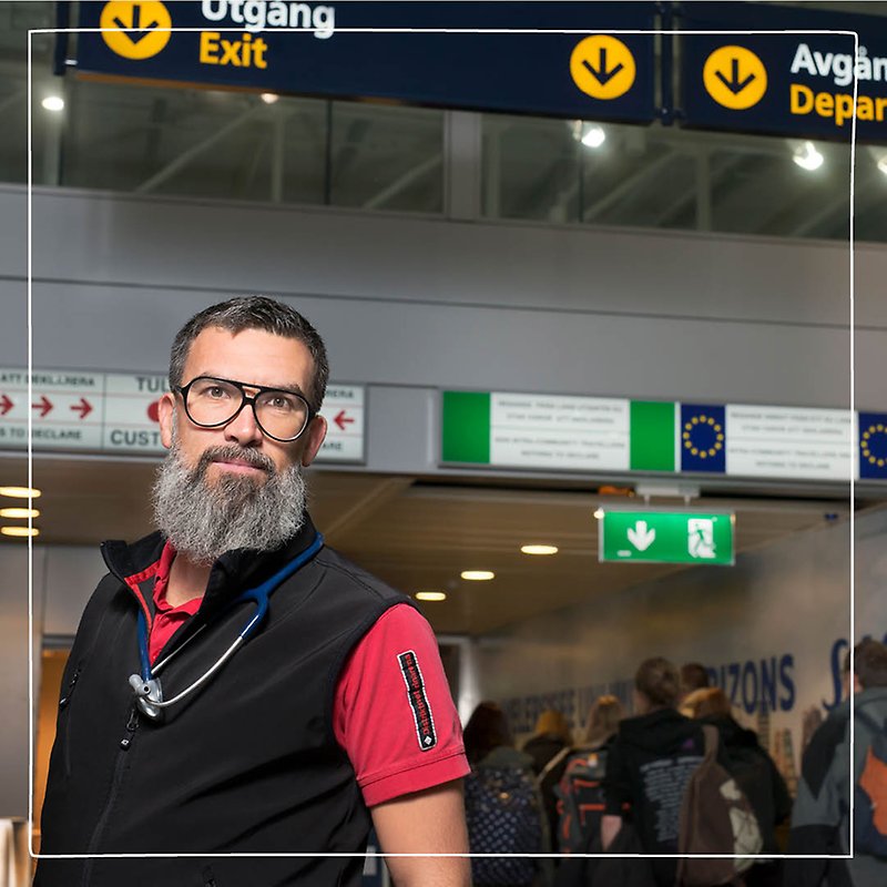 Närbild på en manlig Distriktsveterinär med långt grått skägg som arbetar som gränskontrollant på en flygplats. 